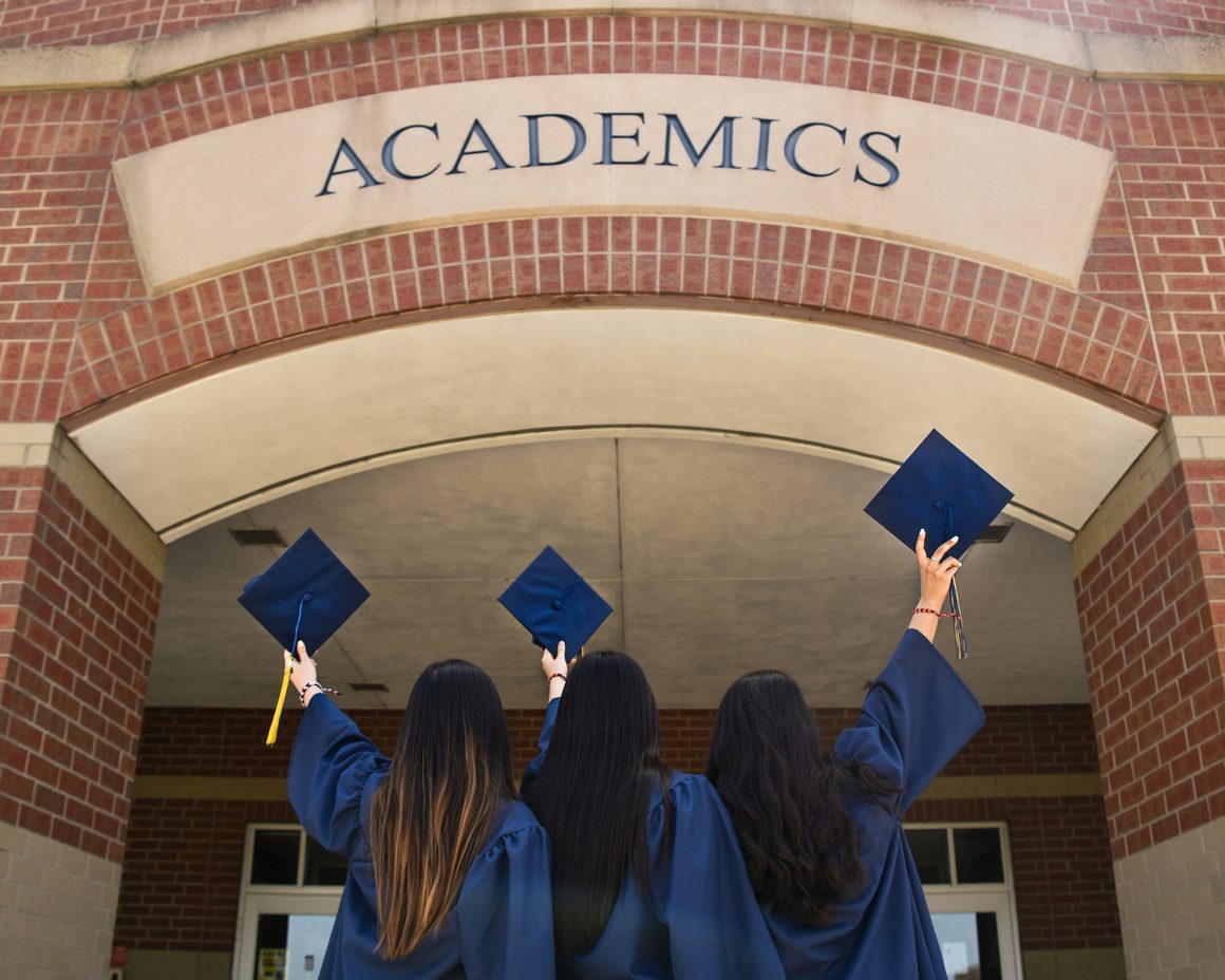 Graduates outside a university building
